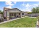 Spacious backyard featuring lush green grass, patio, and ample room for outdoor activities at 455 W Evergreen Pear Ave, Queen Creek, AZ 85140