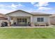 Private yard with a well-maintained lawn, patio area, and mature plantings for privacy at 455 W Evergreen Pear Ave, Queen Creek, AZ 85140