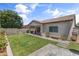 This backyard features lush grass, patio and mature landscaping for added privacy at 455 W Evergreen Pear Ave, Queen Creek, AZ 85140