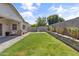 A lush backyard with green lawn, outdoor seating, and well maintained perimeter at 455 W Evergreen Pear Ave, Queen Creek, AZ 85140
