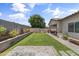 This backyard boasts a well-manicured lawn, a brick paver patio, and mature trees, making it ideal for relaxation and entertainment at 455 W Evergreen Pear Ave, Queen Creek, AZ 85140