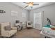 Bright bedroom with gray walls, carpet, two windows and two chairs and desk at 455 W Evergreen Pear Ave, Queen Creek, AZ 85140