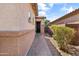 Pathway leading to front door, showing the exterior wall and landscaping of the single-story home at 455 W Evergreen Pear Ave, Queen Creek, AZ 85140