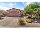 Charming single-story home featuring a brick driveway, desert landscaping, and a two-car garage at 455 W Evergreen Pear Ave, Queen Creek, AZ 85140