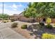 A charming single-story home with desert landscaping, brick driveway, and a two-car garage at 455 W Evergreen Pear Ave, Queen Creek, AZ 85140