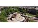 This aerial showcases a vibrant playground in the neighborhood with modern play structures, providing an engaging space for children to play at 455 W Evergreen Pear Ave, Queen Creek, AZ 85140