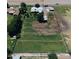 An aerial view features the residence with a large yard, surrounded by green spaces and mature trees at 5016 W Sunrise Dr, Laveen, AZ 85339