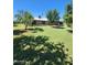 Large, private backyard with lush greenery and mature trees, great for outdoor entertaining and relaxation at 5016 W Sunrise Dr, Laveen, AZ 85339