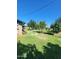 Large backyard with mature trees, manicured lawn and room to grow or add outdoor amenities at 5016 W Sunrise Dr, Laveen, AZ 85339