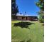 Wide backyard with mature trees providing shade and privacy; perfect for outdoor enjoyment and relaxation at 5016 W Sunrise Dr, Laveen, AZ 85339