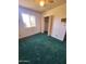 Bedroom featuring plush green carpet, large window, and closet at 5016 W Sunrise Dr, Laveen, AZ 85339