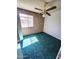 Bedroom features a classic brick wall, a ceiling fan, and a bright window at 5016 W Sunrise Dr, Laveen, AZ 85339