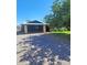 Charming property featuring a covered parking area with a tree for shade on a sunny day at 5016 W Sunrise Dr, Laveen, AZ 85339