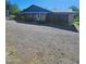 Property featuring a covered parking area, garden, and well-maintained gravel driveway at 5016 W Sunrise Dr, Laveen, AZ 85339