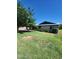 A charming single-story house with a well-manicured lawn and mature tree providing shade at 5016 W Sunrise Dr, Laveen, AZ 85339