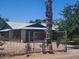 Home with unique metal cactus and leafy palm tree in front at 5016 W Sunrise Dr, Laveen, AZ 85339
