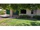 Charming single-story home featuring a lush front yard with mature trees offering plenty of shade at 5016 W Sunrise Dr, Laveen, AZ 85339