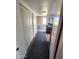 Hallway leads to a bedroom with brick accent wall and ensuite bathroom at 5016 W Sunrise Dr, Laveen, AZ 85339