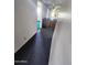 Hallway showing storage cabinets leading to a bedroom with lush green carpet at 5016 W Sunrise Dr, Laveen, AZ 85339