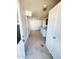 Well lit laundry room with white washer and dryer, tile floor and ample cabinet space at 5016 W Sunrise Dr, Laveen, AZ 85339