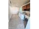Bright laundry area featuring a washer, dryer, utility sink, and dark wood cabinets at 5016 W Sunrise Dr, Laveen, AZ 85339