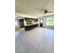 Open living room with tile flooring and bar seating at the kitchen counter at 5016 W Sunrise Dr, Laveen, AZ 85339