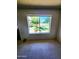 Sunlit room with a large window offering views of the green yard at 5016 W Sunrise Dr, Laveen, AZ 85339