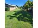Spacious side yard with lush green grass and ample space for outdoor activities and landscaping at 5016 W Sunrise Dr, Laveen, AZ 85339