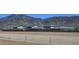 View of neighborhood houses in front of the mountains with beautiful desert scenery and a secure fenced perimeter at 5016 W Sunrise Dr, Laveen, AZ 85339