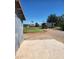 View of the property featuring multiple outbuildings and large grassy area with trees at 5016 W Sunrise Dr, Laveen, AZ 85339