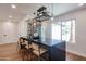 Modern bar area with a built-in wine rack, pendant lighting, and seating for enjoying drinks and entertaining at 5259 E Karen Dr, Scottsdale, AZ 85254