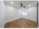 Simple bedroom featuring hardwood floors, a ceiling fan, and a window at 5259 E Karen Dr, Scottsdale, AZ 85254