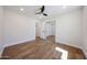 Bright bedroom featuring hardwood floors, large sliding-mirror closet, and ceiling fan at 5259 E Karen Dr, Scottsdale, AZ 85254