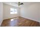 Well-lit bedroom featuring hardwood floors, a window, and ceiling fan at 5259 E Karen Dr, Scottsdale, AZ 85254