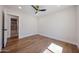 Clean and bright bedroom with hardwood floors and view to an adjoining tiled bathroom at 5259 E Karen Dr, Scottsdale, AZ 85254