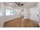 Bright bedroom featuring wood floors, a modern ceiling fan, closet with mirrored doors, and natural light at 5259 E Karen Dr, Scottsdale, AZ 85254
