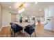 Bright dining area featuring a modern chandelier, stylish table, and seamless flow to the well-equipped kitchen at 5259 E Karen Dr, Scottsdale, AZ 85254