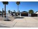 Charming single-story home features desert landscaping, dark trim, a two-car garage, and solar panels at 5259 E Karen Dr, Scottsdale, AZ 85254