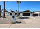 Charming single-story home features desert landscaping, dark trim, a two-car garage, and solar panels at 5259 E Karen Dr, Scottsdale, AZ 85254