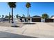 Charming home features desert landscaping, dark trim, a two-car garage, and solar panels at 5259 E Karen Dr, Scottsdale, AZ 85254