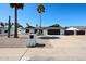 Charming single-story home features desert landscaping, dark trim, a two-car garage, and solar panels at 5259 E Karen Dr, Scottsdale, AZ 85254