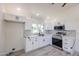Well-lit kitchen featuring stainless steel appliances, modern finishes, white cabinets, and ample counter space at 5259 E Karen Dr, Scottsdale, AZ 85254