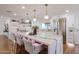 Well-lit kitchen with a large island, modern appliances, and stylish pendant lighting at 5259 E Karen Dr, Scottsdale, AZ 85254