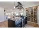 Modern open kitchen featuring a wine rack, wine cooler, and sleek countertops for a contemporary design at 5259 E Karen Dr, Scottsdale, AZ 85254