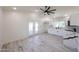 Open floorplan featuring french doors, sleek floors, a modern ceiling fan, and an open kitchen at 5259 E Karen Dr, Scottsdale, AZ 85254