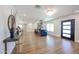 Living room with hardwood floors and a stylish bar, leading to the dining area and modern kitchen at 5259 E Karen Dr, Scottsdale, AZ 85254