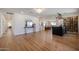 Open-concept living room with hardwood floors, a modern bar, and access to the kitchen and dining areas at 5259 E Karen Dr, Scottsdale, AZ 85254