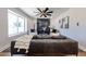 Modern living room featuring a large leather couch and stylish black marble fireplace and a ceiling fan at 5259 E Karen Dr, Scottsdale, AZ 85254