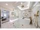 Spa-like main bathroom with marble floors, a luxurious tub, and access to the main bedroom at 5259 E Karen Dr, Scottsdale, AZ 85254