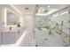 Luxurious main bathroom with marble floors, a freestanding tub, and a frameless glass shower at 5259 E Karen Dr, Scottsdale, AZ 85254